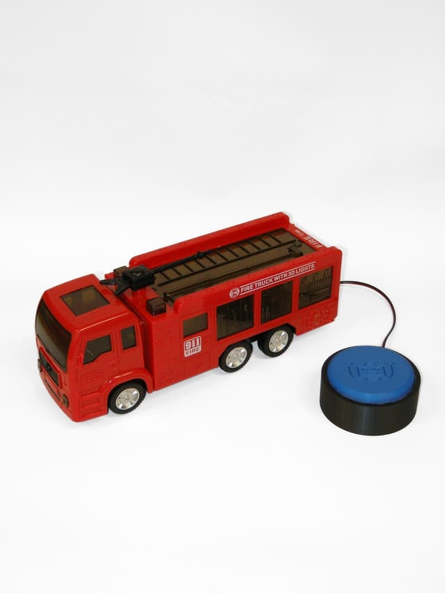 Red fire truck that rolls, makes sounds, and lights up